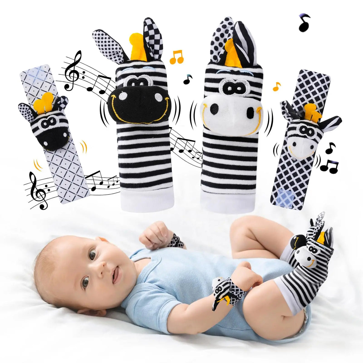 A set of black and white striped baby wrist rattles and foot finder socks with yellow accents shown above a baby lying on a w