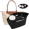 A black felt organizer insert with compartments and a lid is shown next to a beige canvas tote bag.