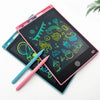 A pink and teal LCD writing tablet is shown with a stylus pen, displaying colorful drawings on the screen.