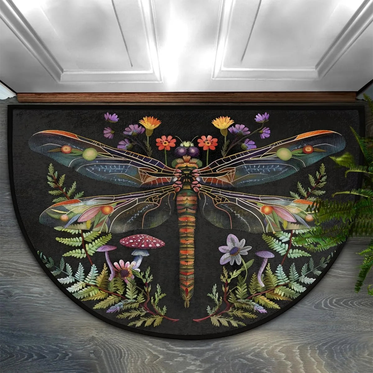A half-round doormat featuring a dark background with colorful floral and dragonfly designs.