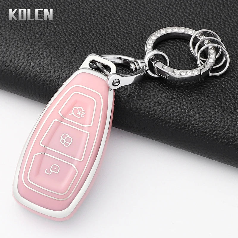 Pink silicone car key fob cover with a silver chain attached, shown against a black background.
