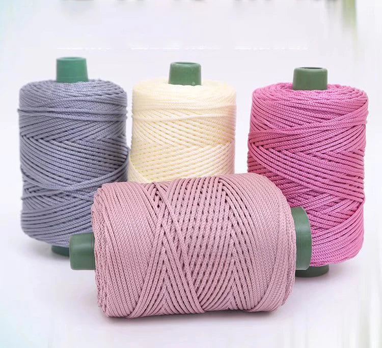 Three spools of colorful crochet ice rope in gray, cream, and pink stacked horizontally.