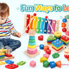 A toddler plays with various wooden puzzles, including stacking rings, geometric blocks, and wooden puzzles.