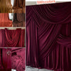 A close-up of rich burgundy stretch jersey fabric draped in luxurious folds for decor and backdrops.