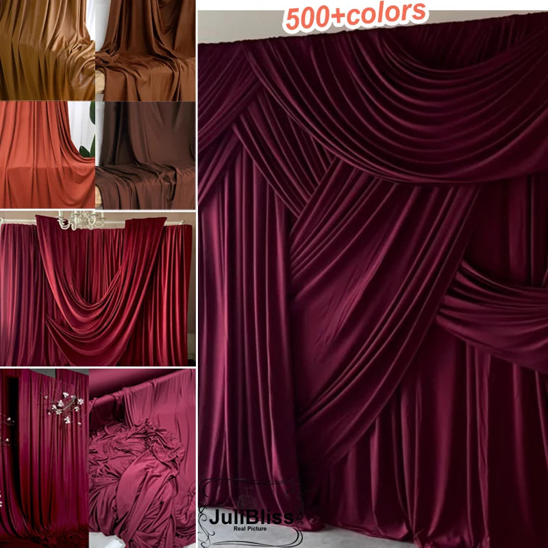 A close-up of rich burgundy stretch jersey fabric draped in luxurious folds for decor and backdrops.