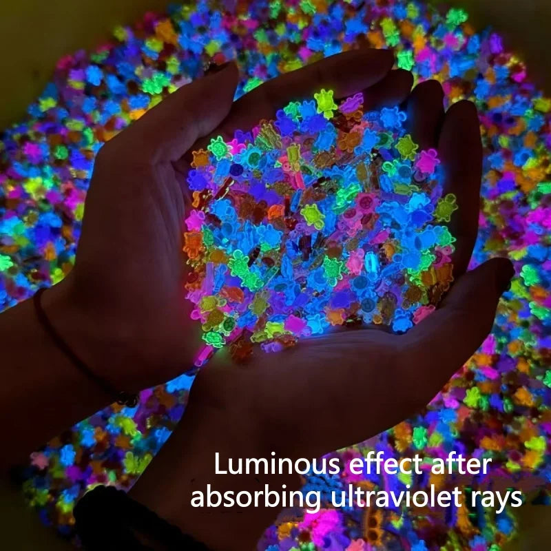 A hand holds a pile of glow-in-the-dark mini turtle figurines showing a luminous effect after absorbing ultraviolet rays.