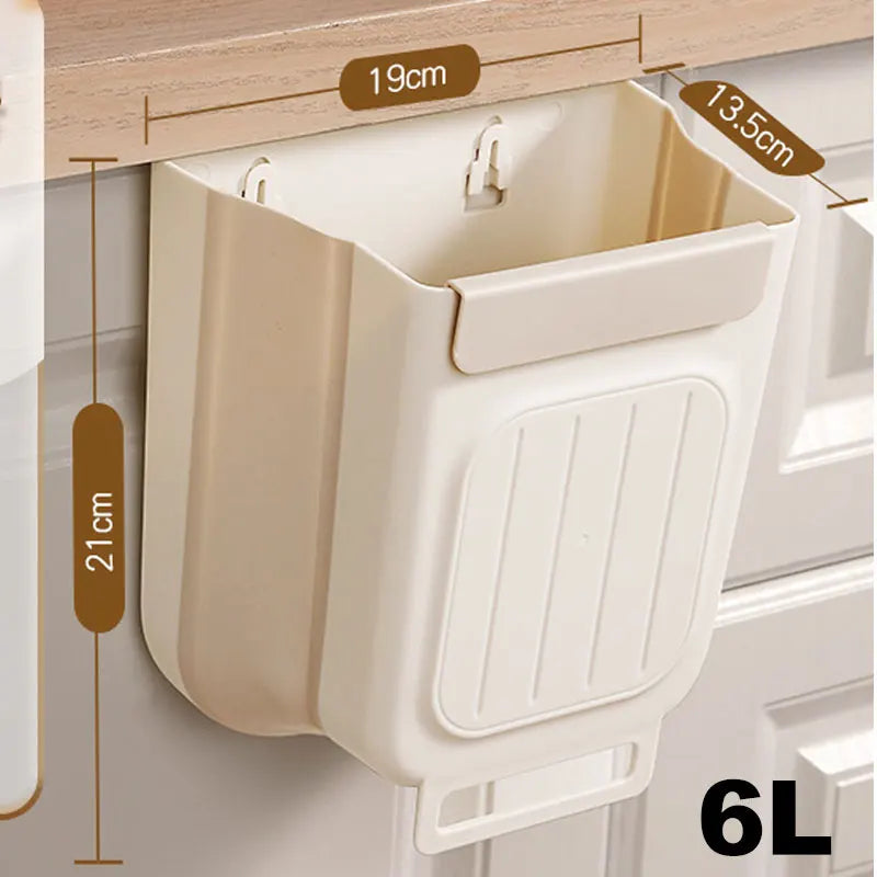 A beige foldable hanging trash can with a ribbed design is shown mounted on a cabinet shelf.