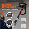 An orange and black brushless drywall sander is shown being used on a wall surface.