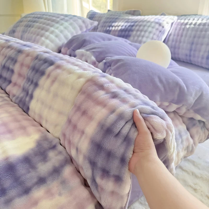 A purple and white plaid fleece duvet cover is shown on a bed, with a white pillow nearby.