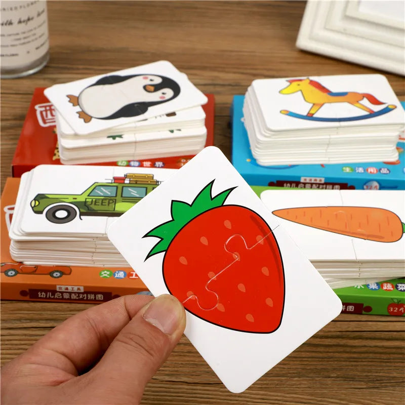 A hand holds a white puzzle card featuring a red strawberry with a green leafy top, placed among stacks of similar cards.