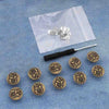 Silver instant no-sew snap button kit for loose jeans placed on a white plastic bag.
