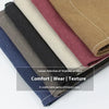 A selection of sixteen folded fabric cloths in various earthy and muted tones for a canvas apron.
