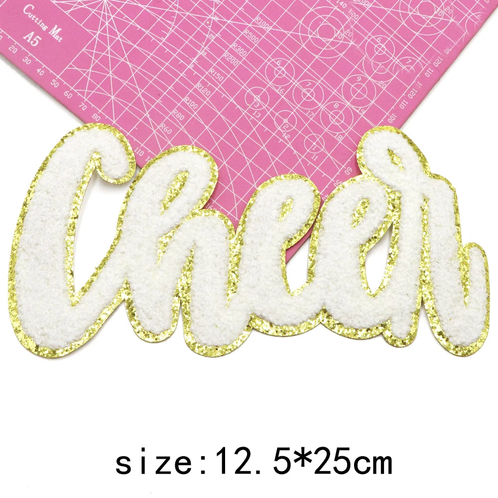 White and gold chenille letter patch spelling Cheer