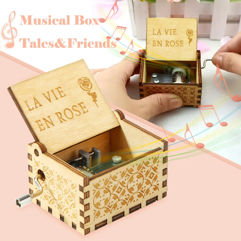 A wooden musical box with a lid open, featuring engraved text and a small metal mechanism.