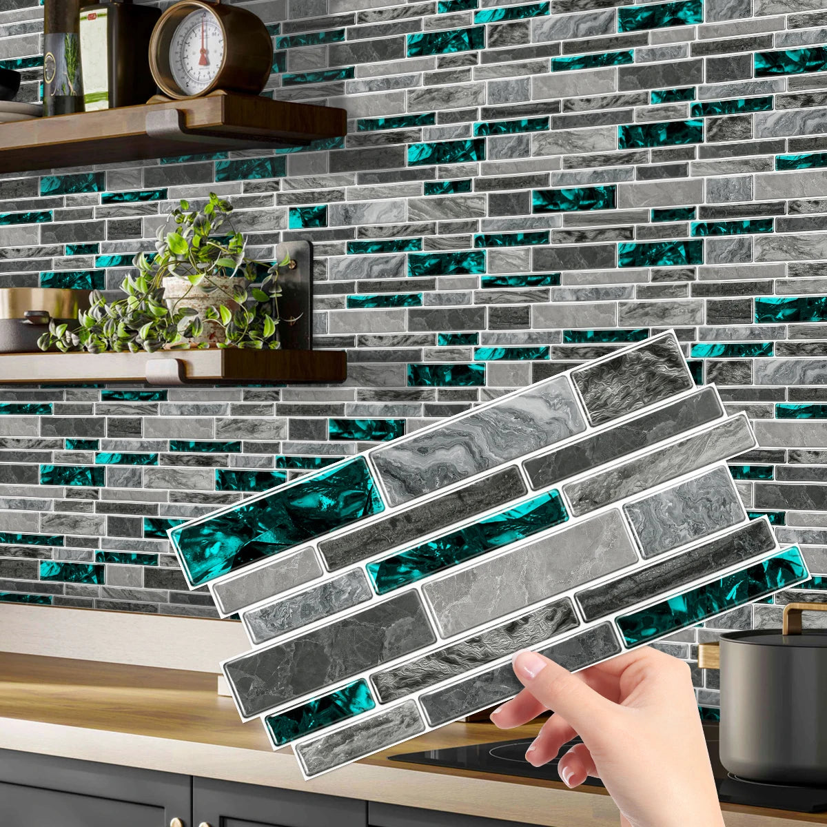 A hand holds a rectangular peel and stick waterproof tile sticker featuring marbled gray and teal accents against a subway ti