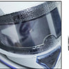 Close-up view of a motorcycle helmet with anti-fog and rain shield film applied, showing water droplets on the surface.