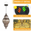 A decorative solar-powered Moroccan lantern with intricate ironwork design.