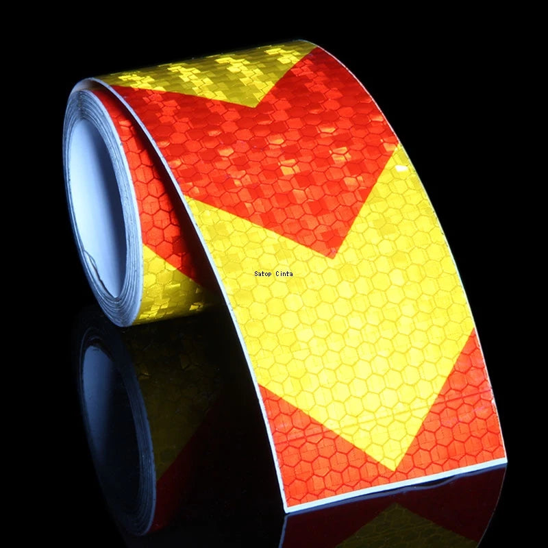Roll of high-visibility reflective safety tape featuring a red and yellow chevron pattern.