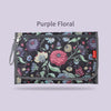 Purple floral foldable baby changing mat with a waterproof cover and storage bag