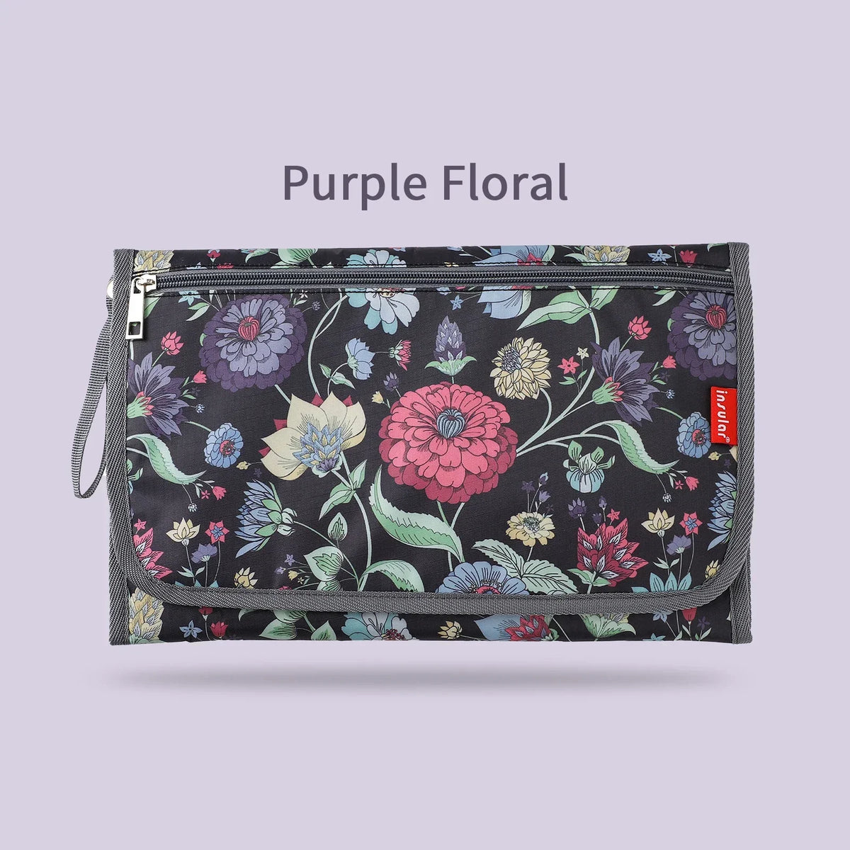 Purple floral foldable baby changing mat with a waterproof cover and storage bag