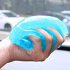 A hand holds a translucent blue reusable cleaning gel, demonstrating its texture and use for car interiors.