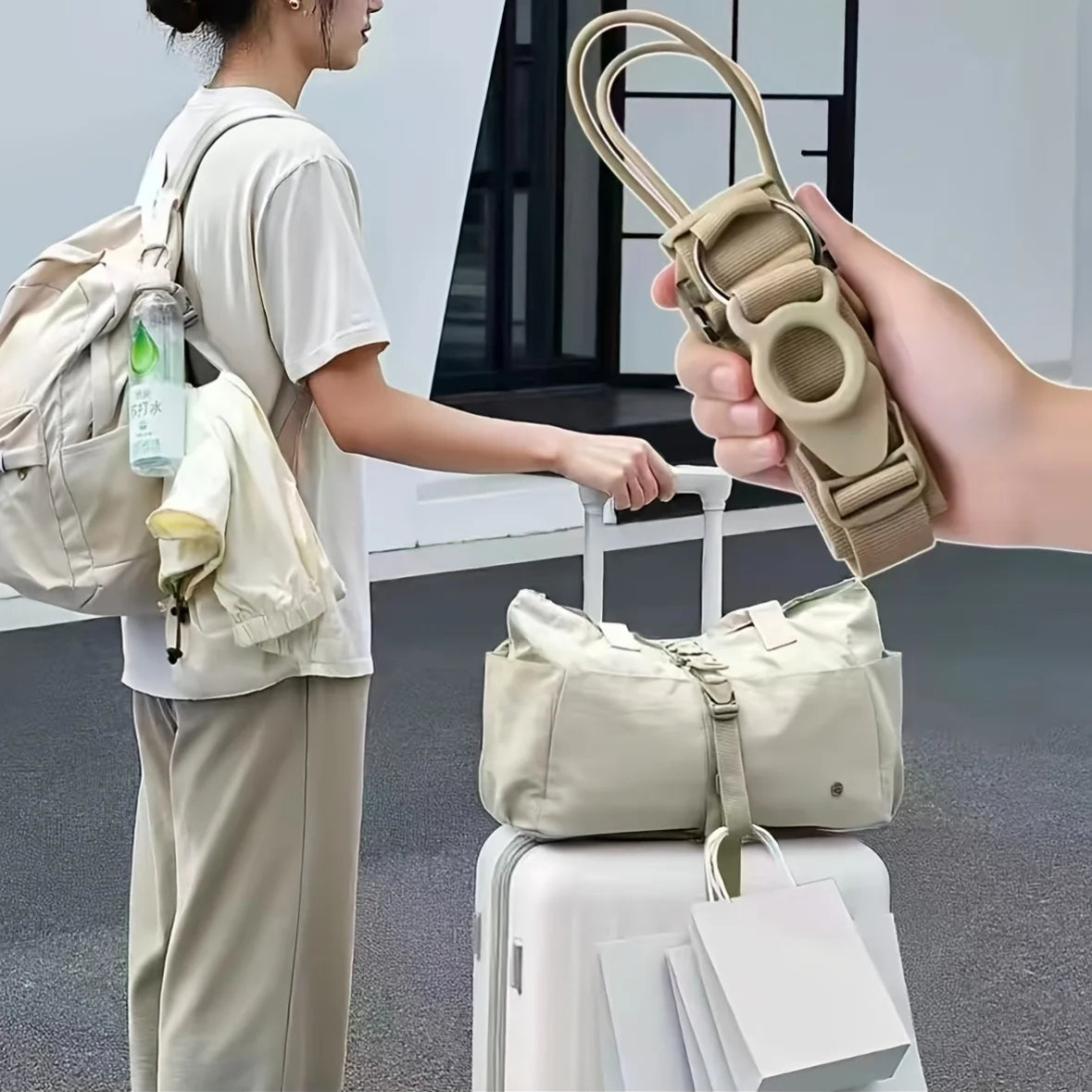 A hand is holding an adjustable luggage strap with a quick-release buckle, demonstrating its use for securing a backpack.