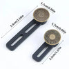 A pair of black metal jeans button extenders with brass accents shown with dimension lines.