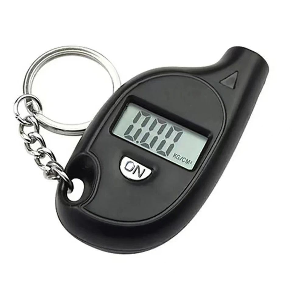 Black digital tire pressure gauge with an LCD display and metal chain for measurement