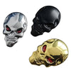 Three skull emblems in chrome, black, and gold finish displayed against a white background.