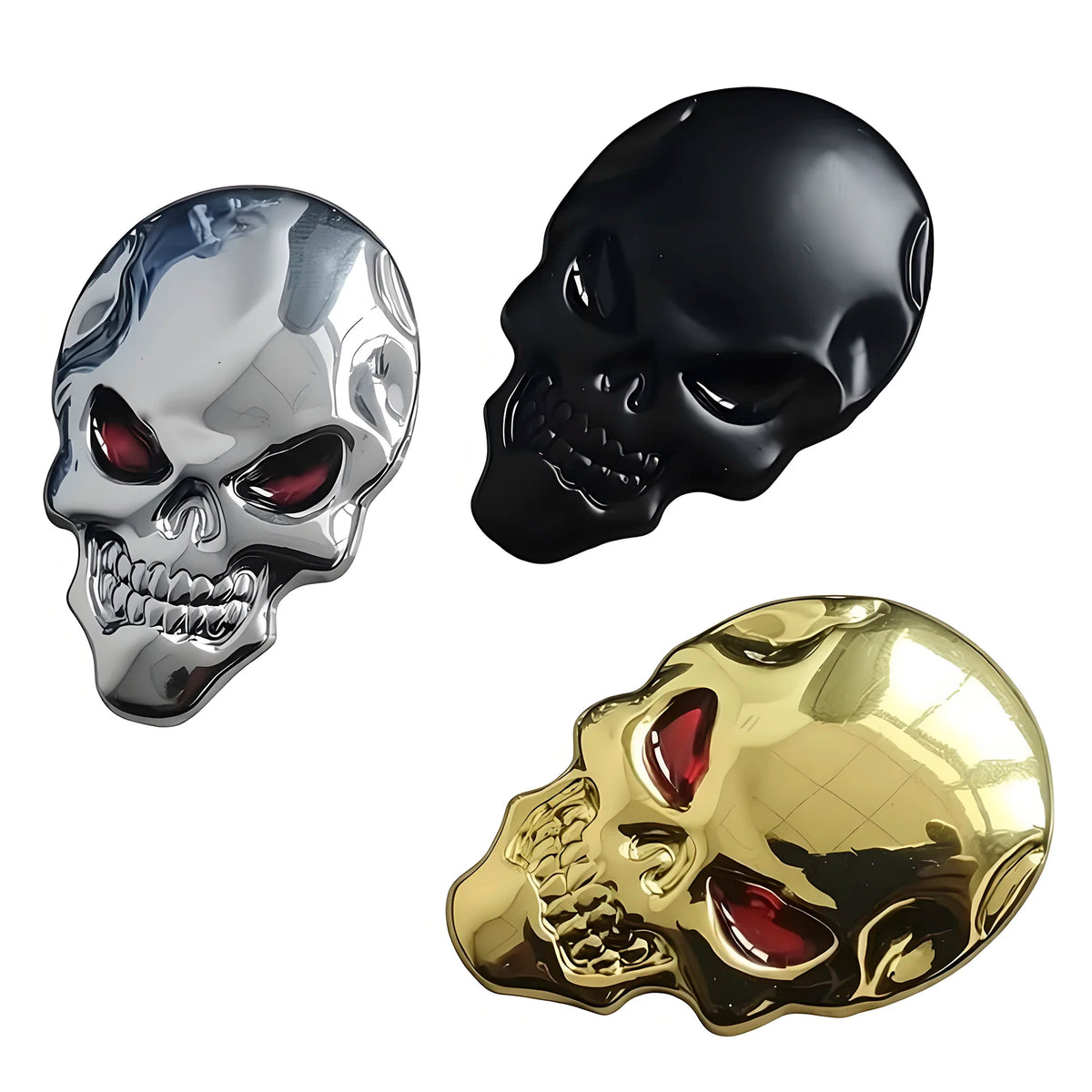 Three skull emblems in chrome, black, and gold finish displayed against a white background.