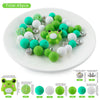 A collection of 45 silicone 3D animal beads in various shades of green and white are displayed on a white plate.