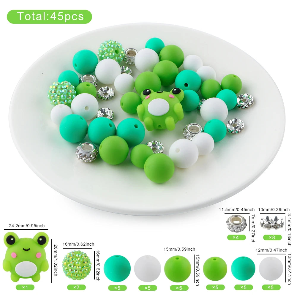 A collection of 45 silicone 3D animal beads in various shades of green and white are displayed on a white plate.
