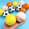 A hand holds a set of three soft foam sports stress balls in various colors including yellow, orange, and white.