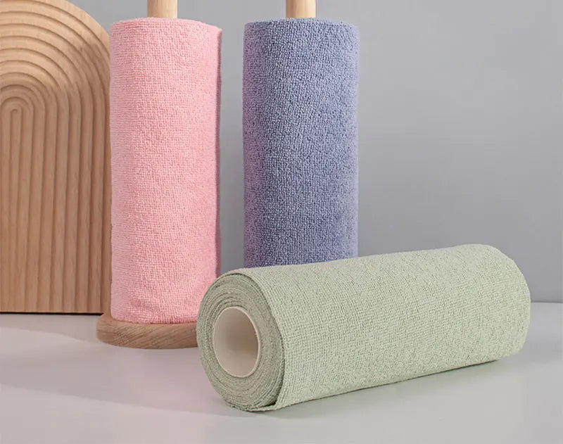 Three rolls of reusable microfiber cleaning towels in pink, purple, and light green stacked vertically.