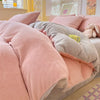 A pink and gray cozy milk velvet bedding set featuring a duvet cover and pillows.