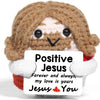 Handmade crochet hedgehog doll with a brown textured body and white accents holding an inspirational card