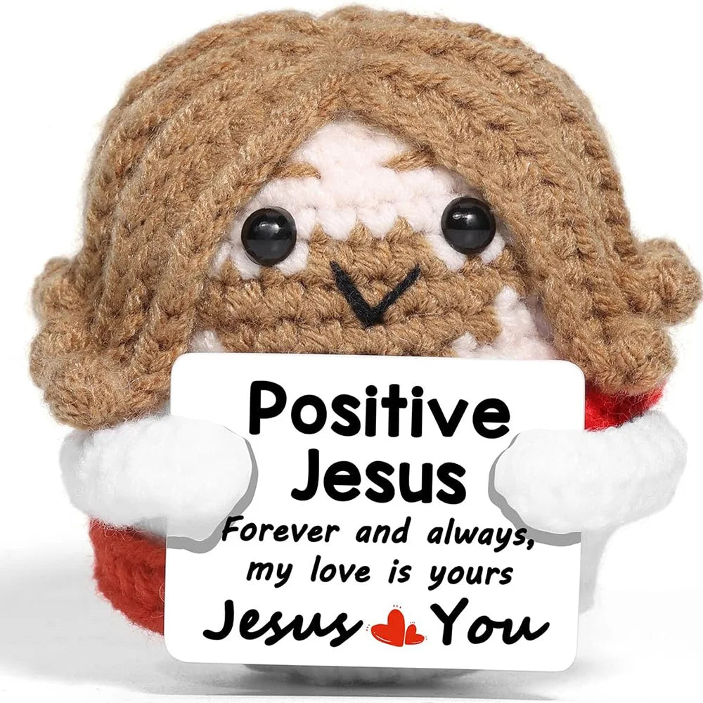 Handmade crochet hedgehog doll with a brown textured body and white accents holding an inspirational card