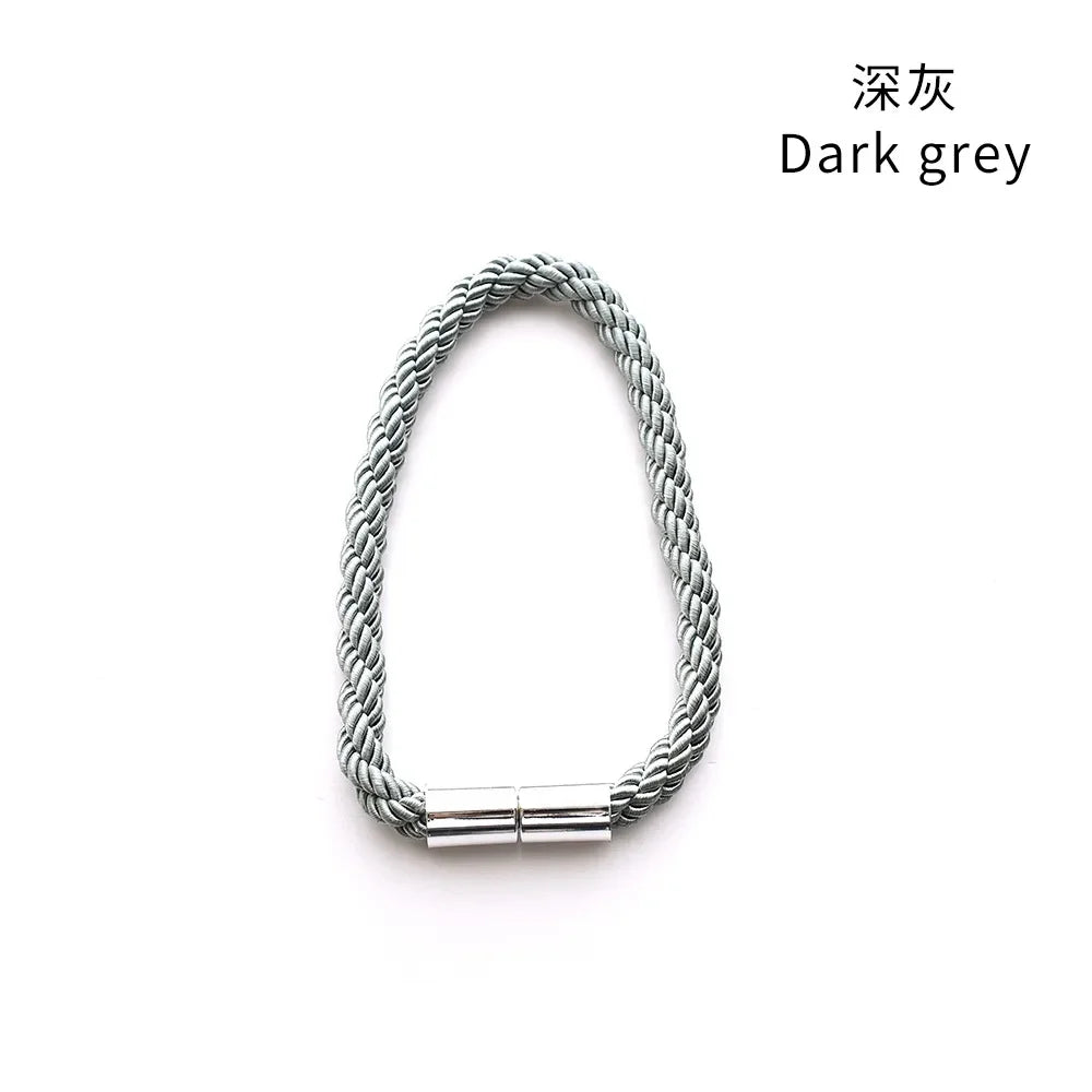 A set of two dark grey magnetic curtain tiebacks with rope and metal buckle clasps.