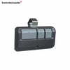 A gray universal keychain garage door remote for LiftMaster and Craftsman.