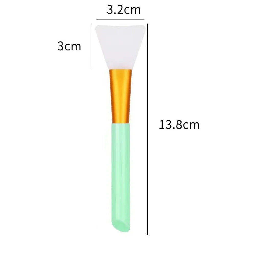 A silicone facial mask brush with a white tapered head and an orange handle, shown next to dimension lines.