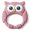A pink owl-shaped silicone teether and rattle for babies with large eyes and rounded features.