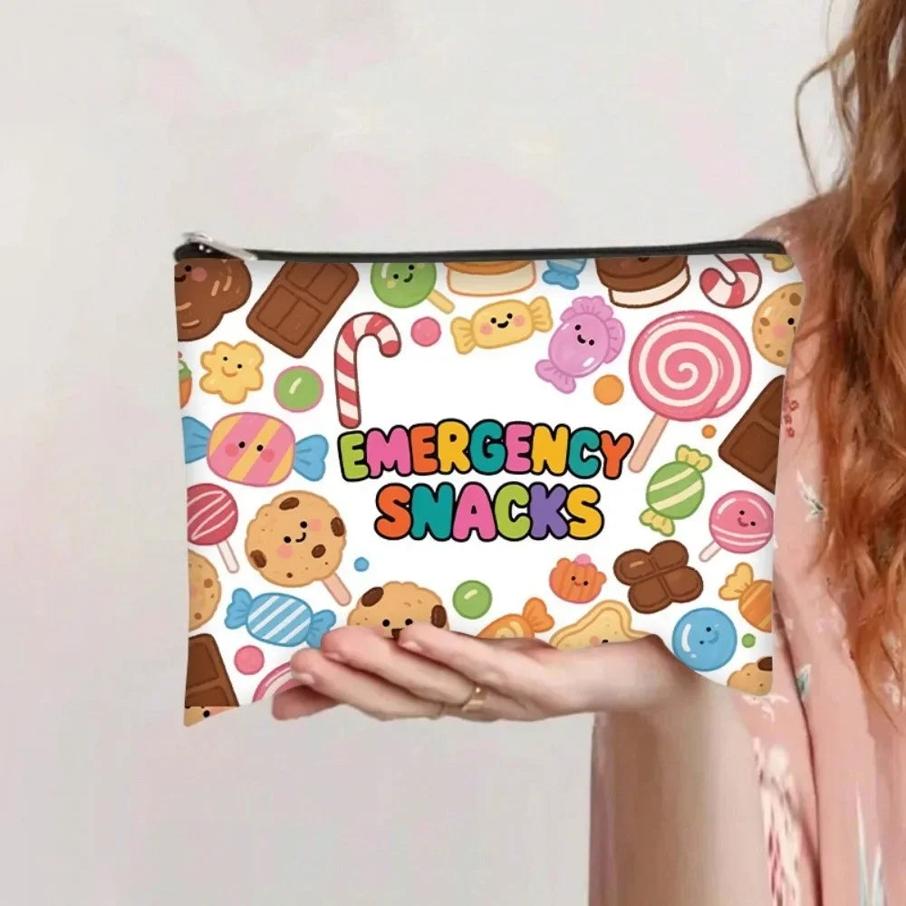 A canvas storage pouch filled with various emergency snacks including cookies, candies, and fruit.