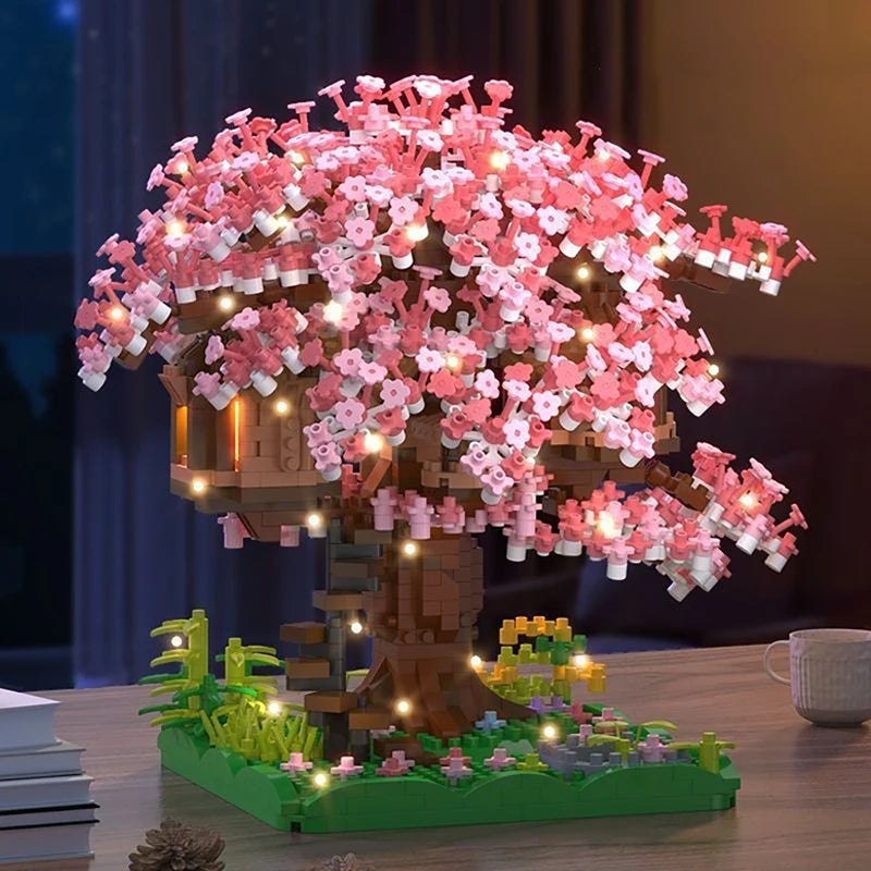 A detailed model of a pink sakura tree with glowing LED lights, built from micro building blocks.