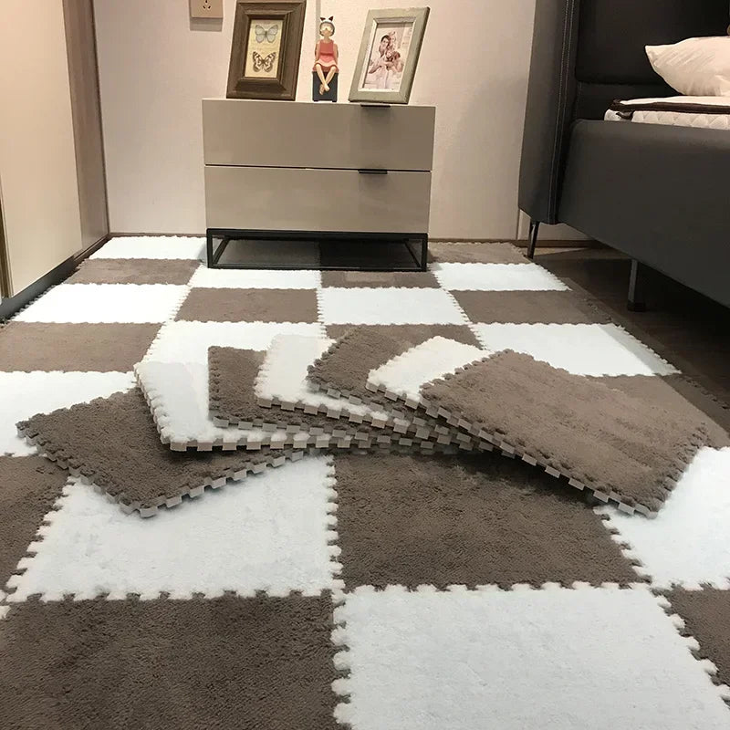 A floor covered with soft plush interlocking tiles in a white and gray checkerboard pattern.
