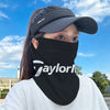 A person wearing a black neck gaiter and cap is shown outdoors under a blue sky.