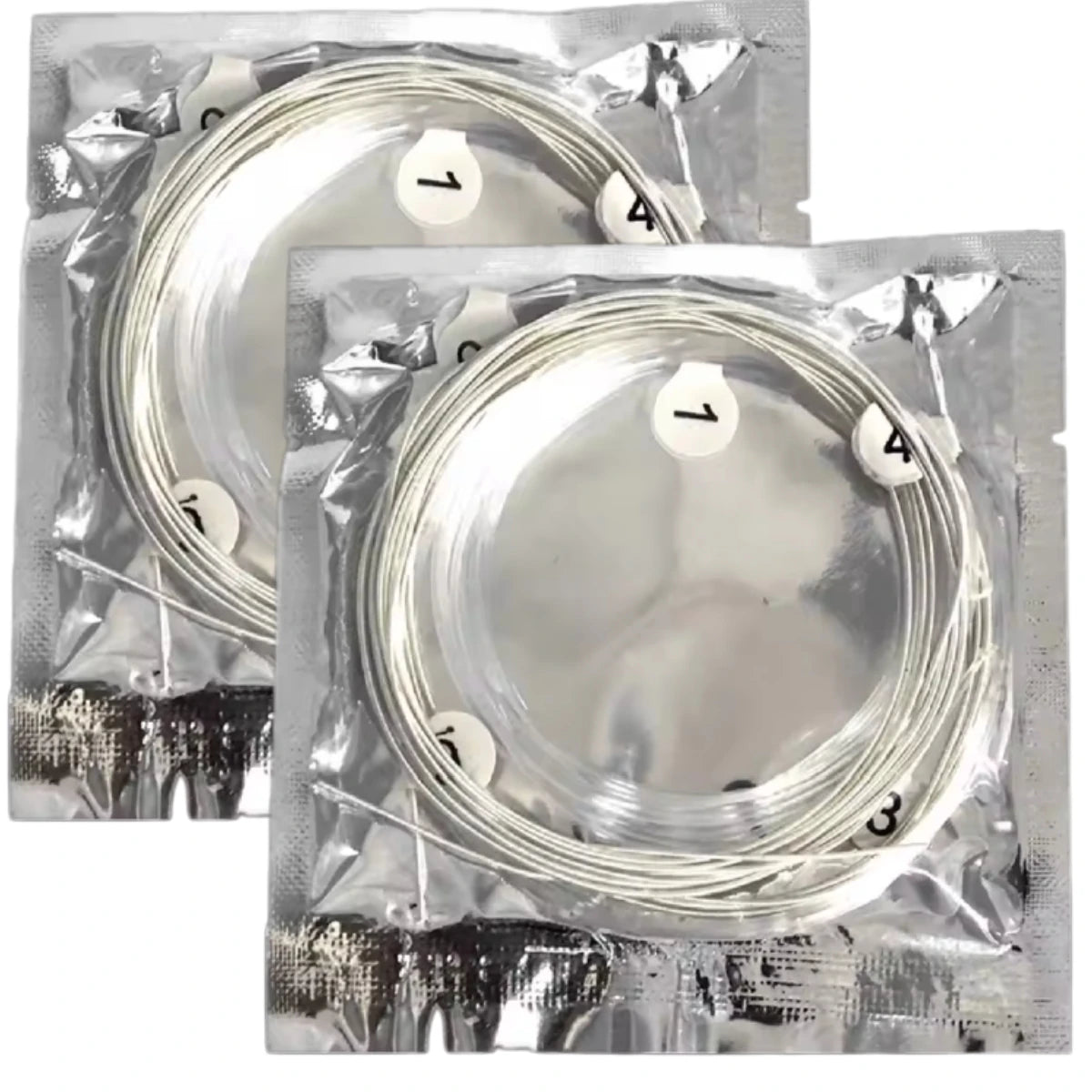 A clear plastic package containing a set of silver-plated nylon classical guitar strings, numbered for identification.
