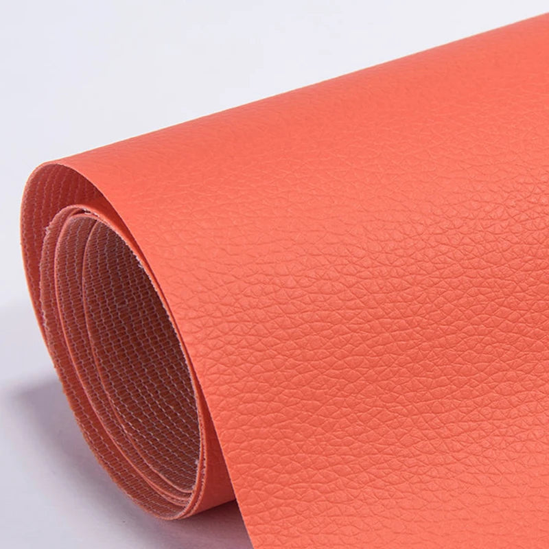 Roll of orange self-adhesive PU leather repair patches, showing the texture and roll.