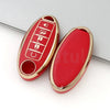 A red and gold durable TPU car key case cover for Nissan and Infiniti models.