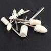 A collection of white wool felt polishing wheels with metal shafts arranged on a dark surface.
