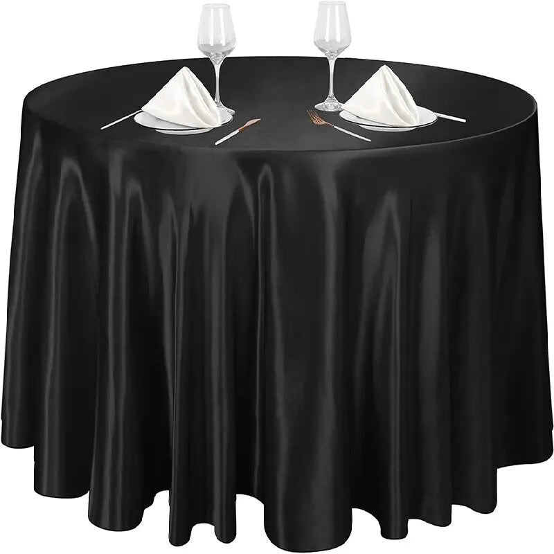 Elegant black satin round tablecloth set with glassware and silverware